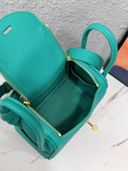 Open teal crossbody bag showing zippered compartments and interior