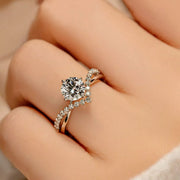Angled view of the silver ring and blue rectangular gemstone on a hand.