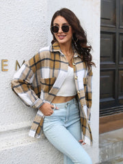 Plaid button-up collared shirt in tan-and-white plaid front view with hand at hip