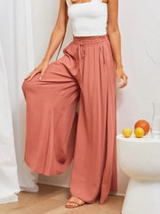Model wearing rose-colored high-waist wide-leg pants, front view