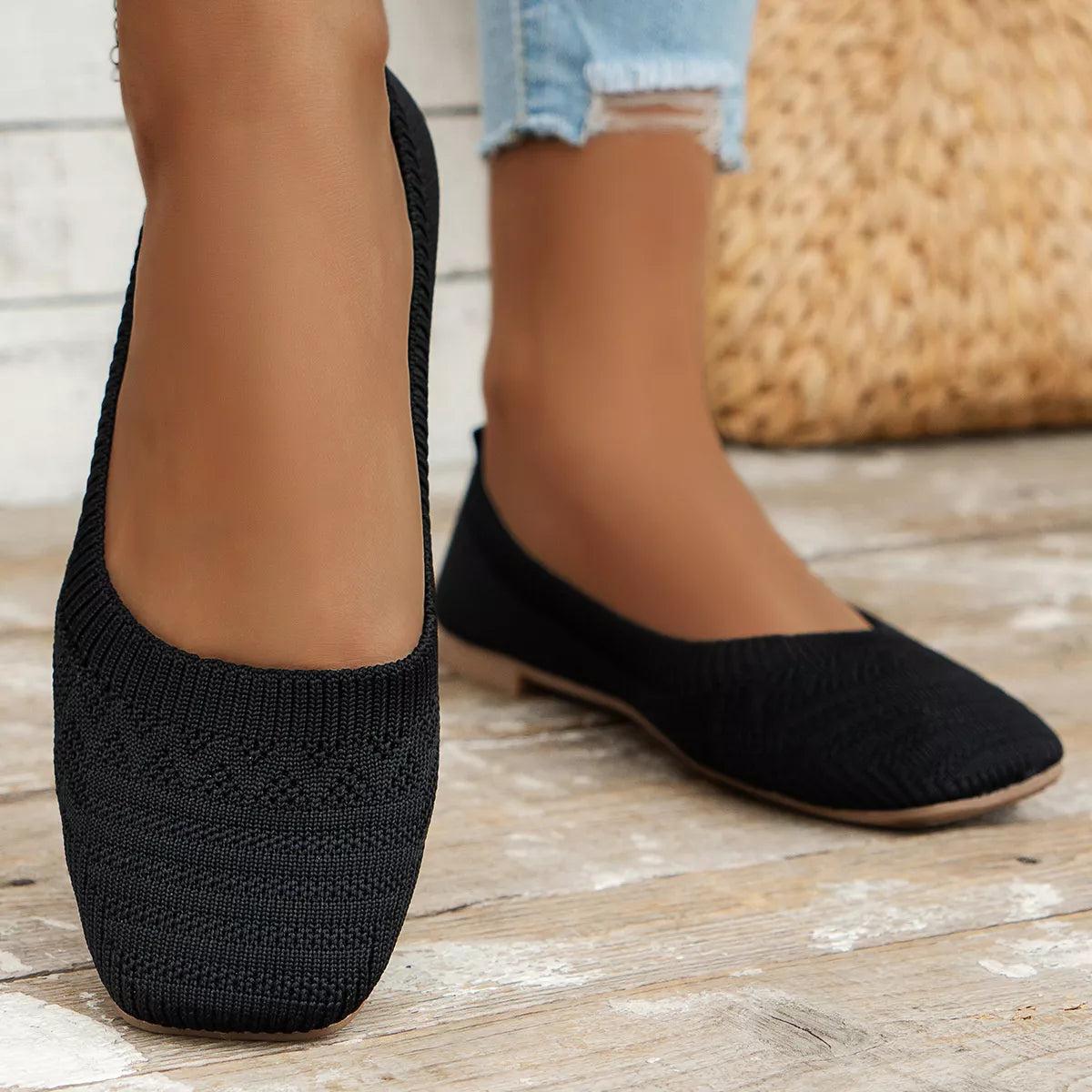 Black square-toe mesh flats worn, showing the patterned toe panels