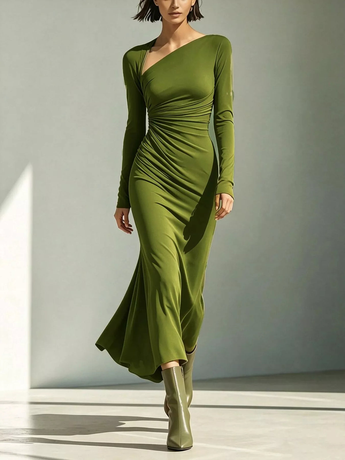 Olive green asymmetrical-neck long-sleeve dress, full-length walking view.