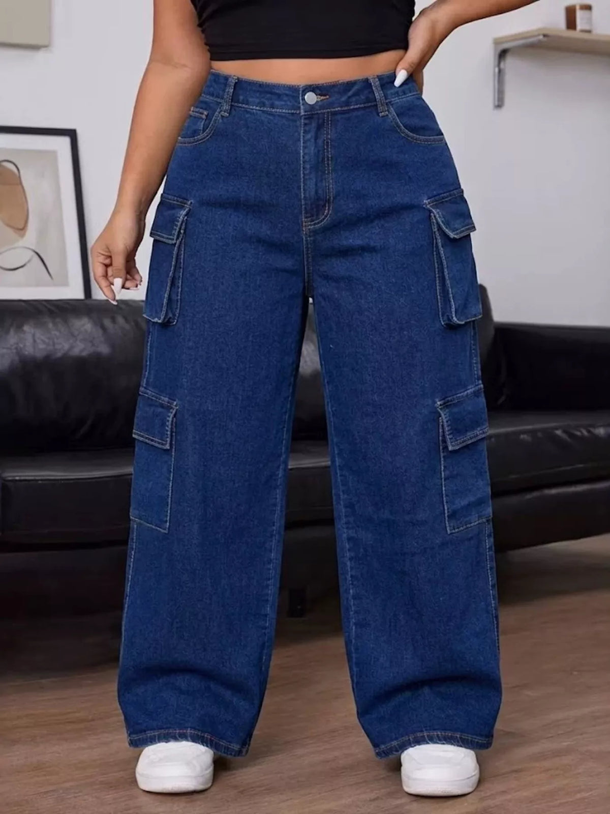 Front view of dark blue cargo jeans showing the button closure and straight wide legs.