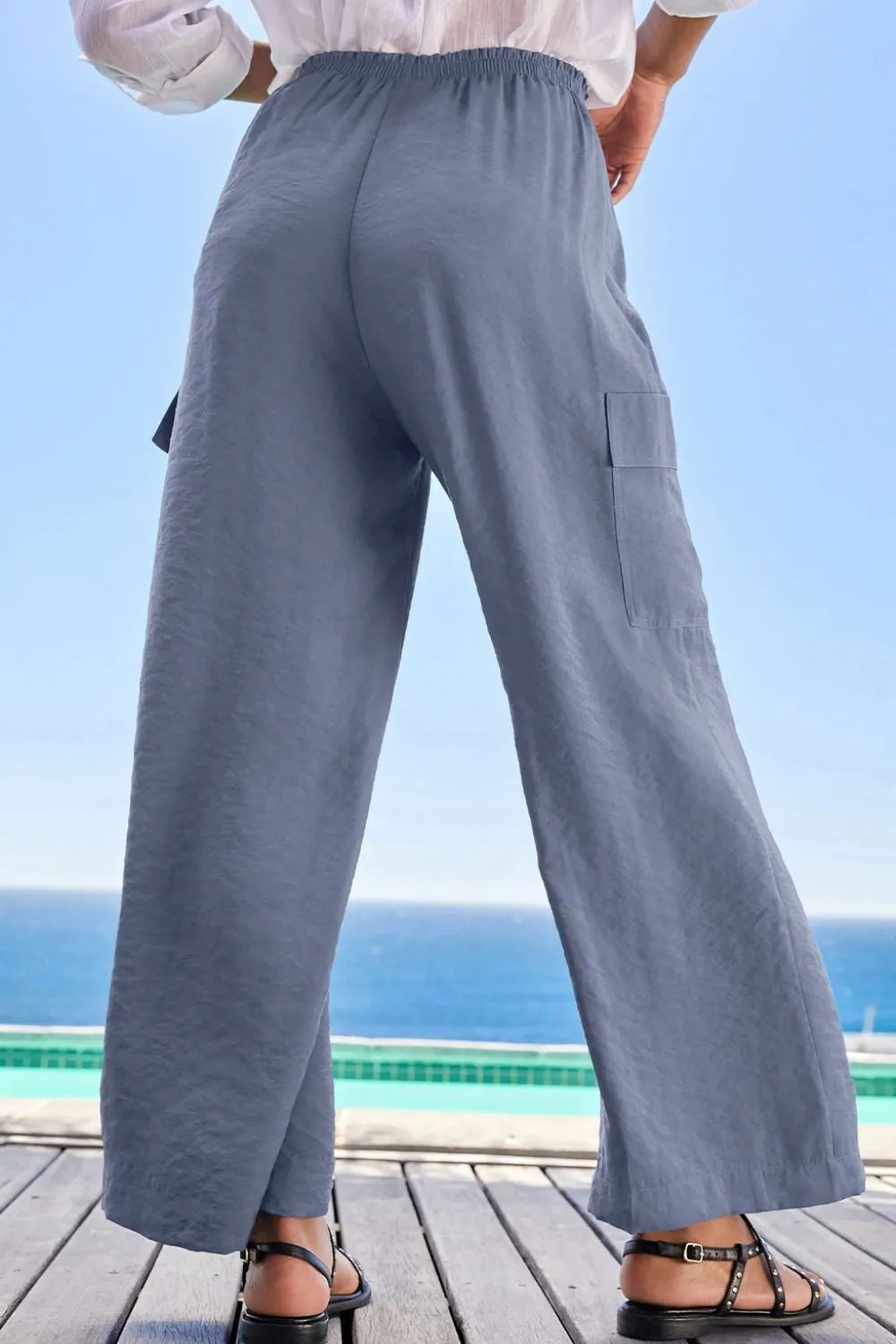 Back view of blue wide-leg trousers with a relaxed fit