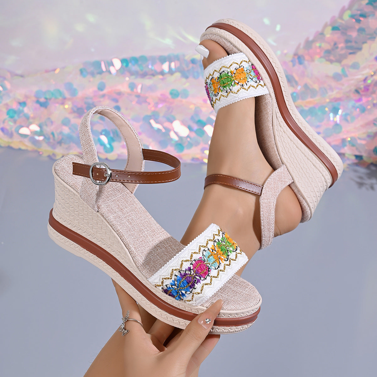 Beige embroidered wedge sandals worn to show the ankle strap and wedge sole