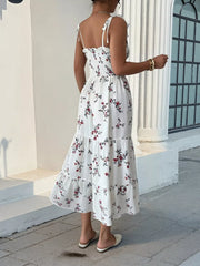 Back view of white floral tiered midi dress with smocked bodice