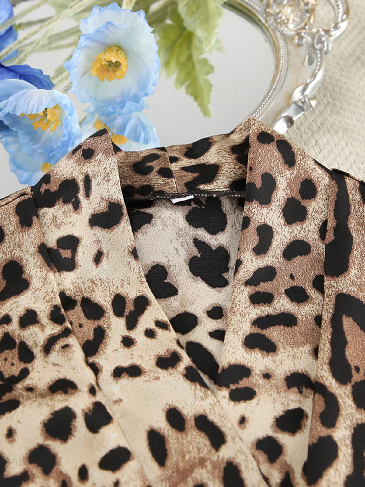 Close-up of leopard-print cardigan collar and neckline