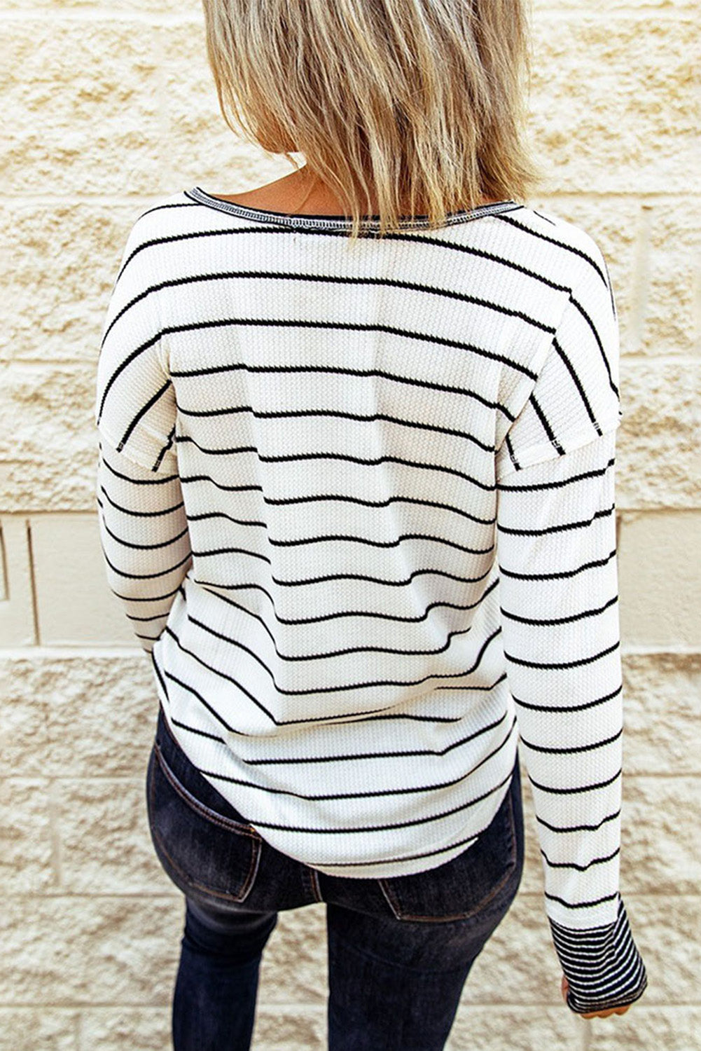 Back view of striped Henley top on model