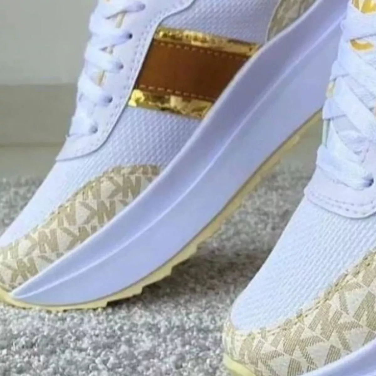 Close-up of gold trim and patterned panel on platform sneakers