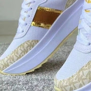 Close-up of gold trim and patterned panel on platform sneakers