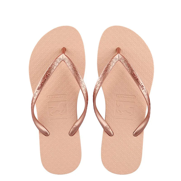 Pair of peach-coloured flip-flops with metallic rose-coloured toe-post straps, top view