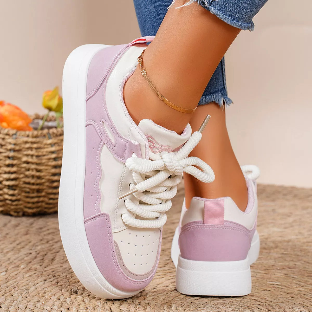 Pink and white sneakers viewed from front