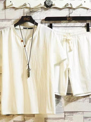 Off-white short-sleeve button-front shirt and matching drawstring shorts on hangers