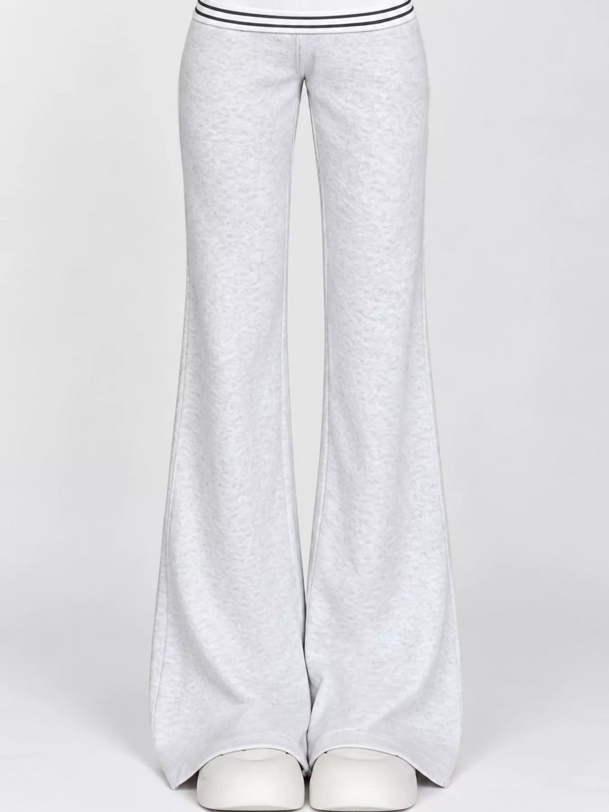 Light grey wide-leg flare pants worn with white shoes, front view