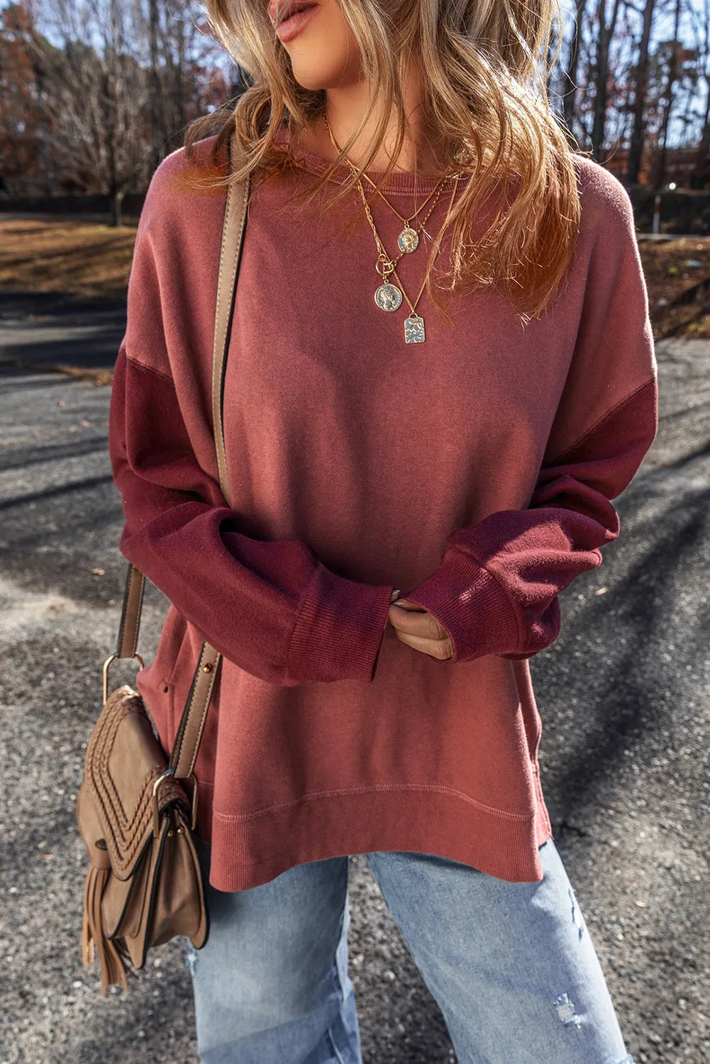 Model wearing dusty mauve contrast-sleeve sweatshirt
