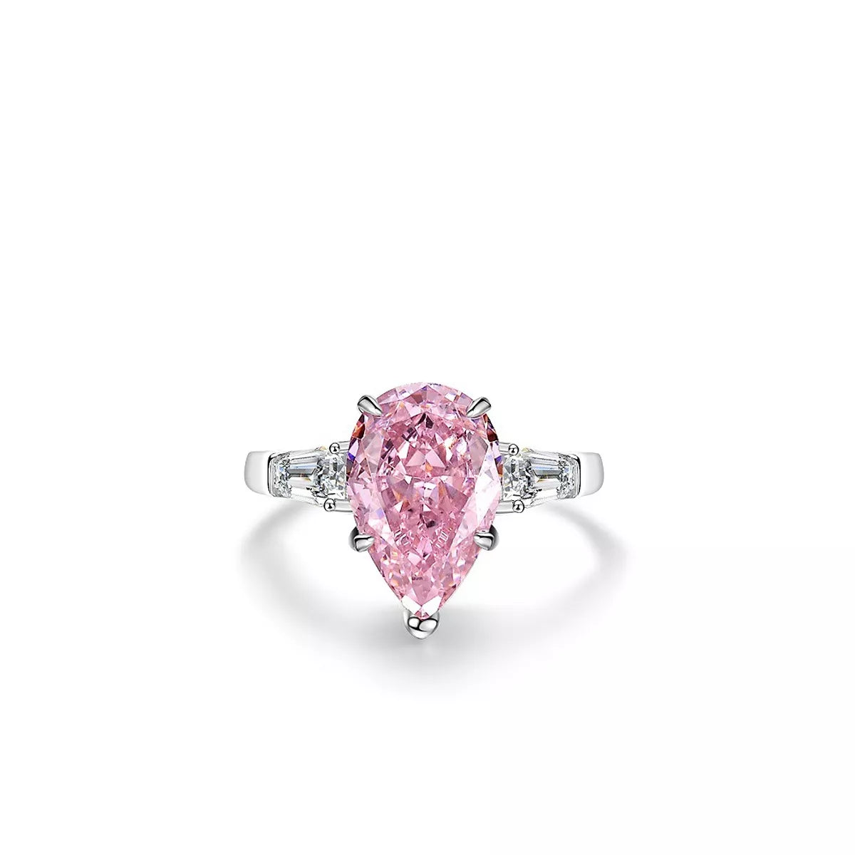 Pink pear-shaped stone ring shown from the side on a light surface.