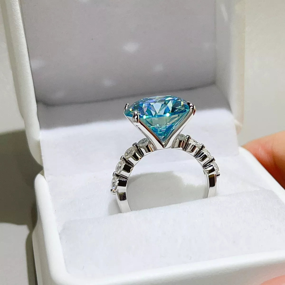 Side profile of blue-green centre stone and silver ring setting