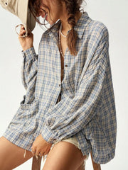 Blue and cream plaid shirt worn open with a relaxed fit and rolled-up sleeve