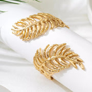 Gold-tone leaf cuff bracelet shown at an angle on light background