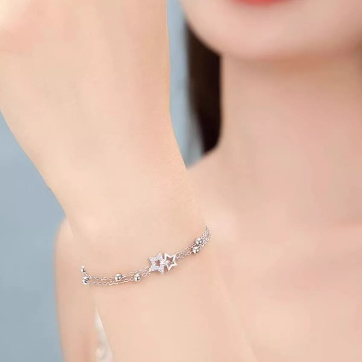 Silver star bracelet worn close around the wrist