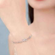 Silver star bracelet worn close around the wrist