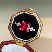 Red rectangular zircon ring presented in a jewellery case.