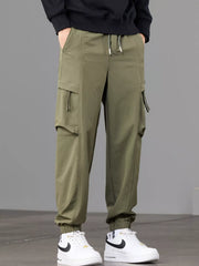 Angled front view of olive cargo joggers with drawstring waist and elastic cuffs.