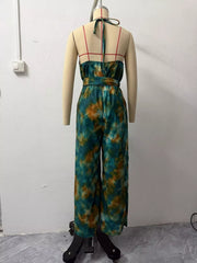 Back view of tie-dye halter jumpsuit on a mannequin