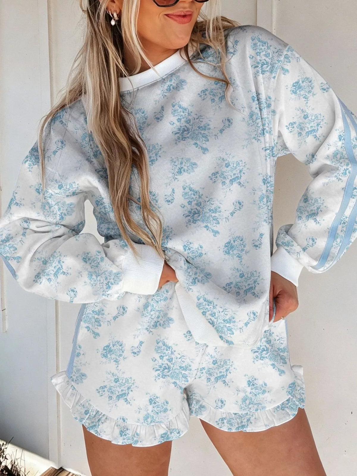White floral-print sweatshirt and ruffle-hem shorts set with blue sleeve stripes