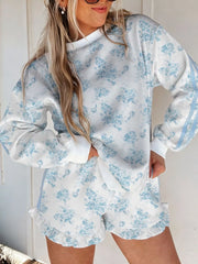White floral-print sweatshirt and ruffle-hem shorts set with blue sleeve stripes