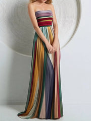 Front view of flowing rainbow-striped pleated maxi dress