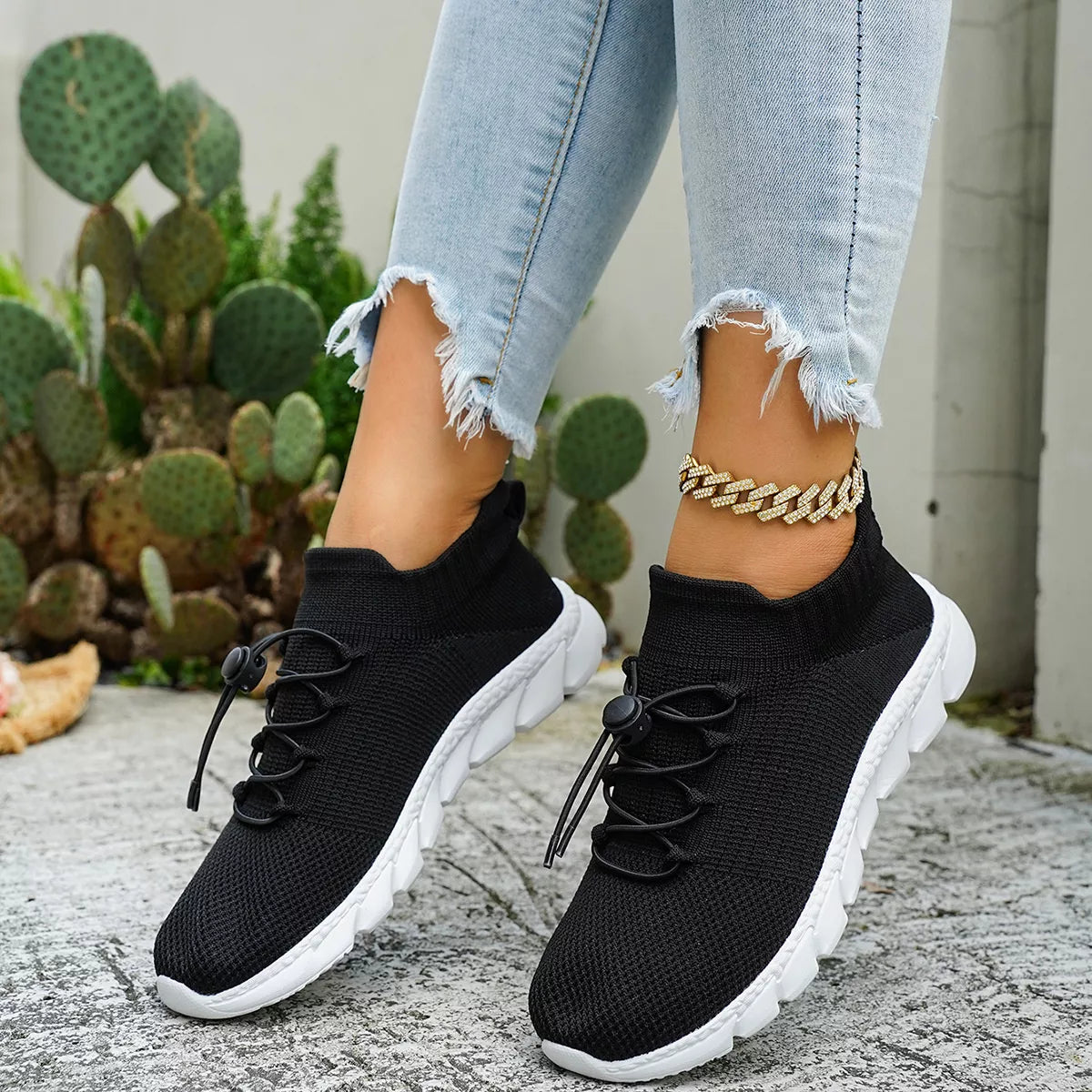 Black knit sneakers shown from the side