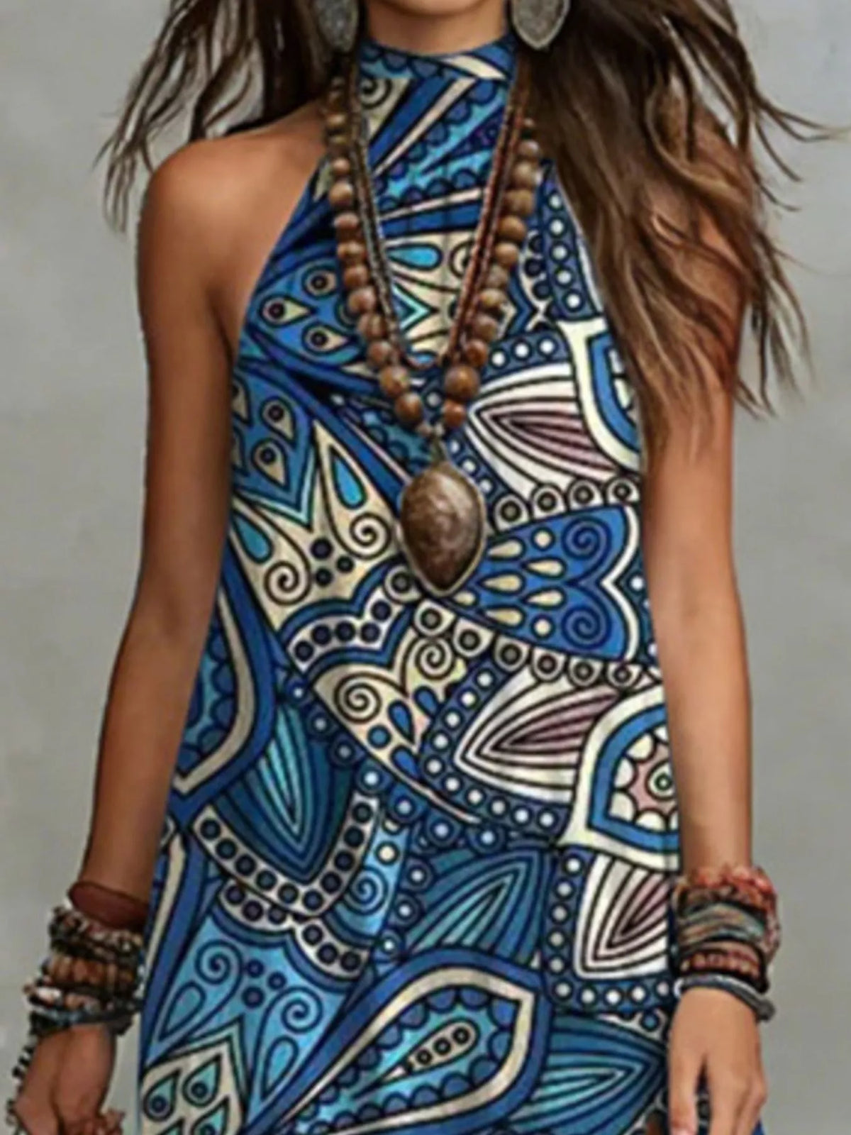 Close view of the blue geometric print and halter-style neckline on the sleeveless maxi dress.