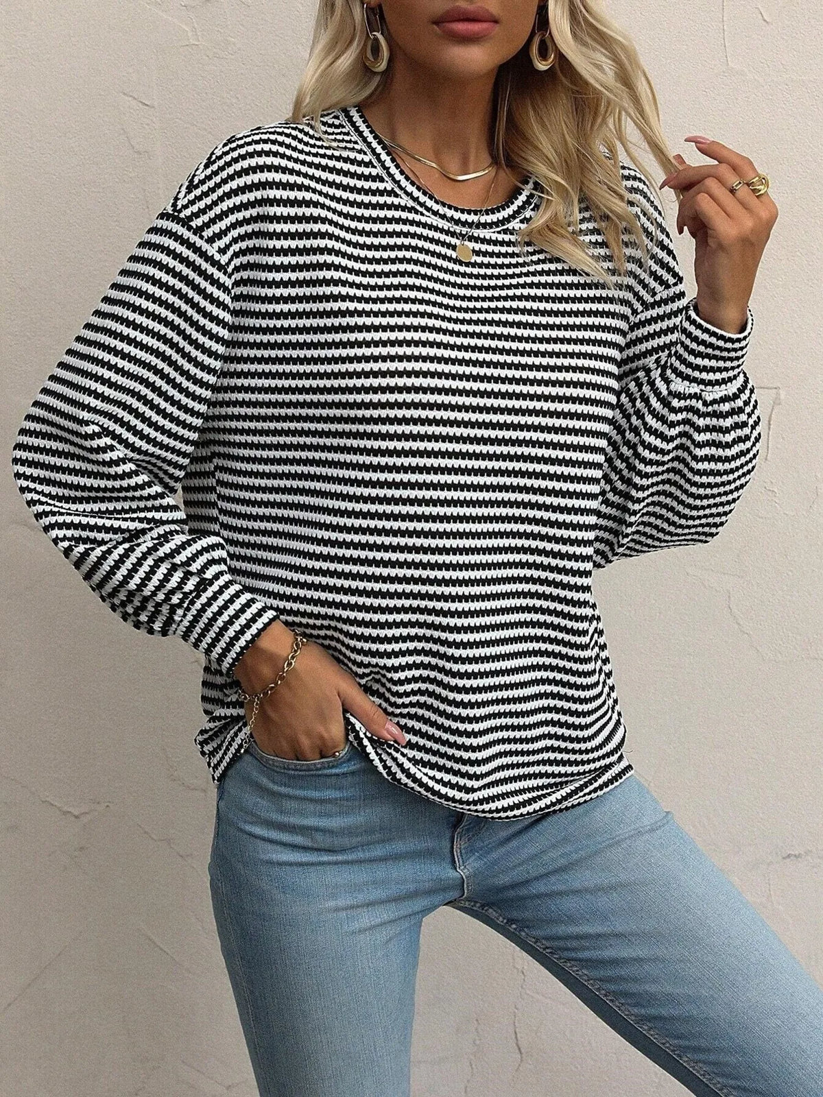 Model wearing a relaxed striped top with lantern sleeves