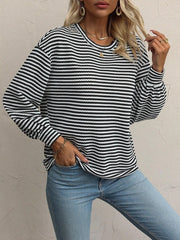 Model wearing a relaxed striped top with lantern sleeves