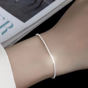 Fine silver chain bracelet shown on a wrist