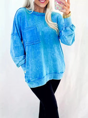 Women's mineral-wash blue raw-seam pocket sweatshirt, model relaxed fit