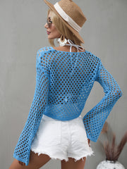 Sage green openwork cover-up modeled with its cropped hem and flared sleeves visible.