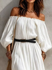 Close view of white off-shoulder maxi dress with black belt and gathered bodice