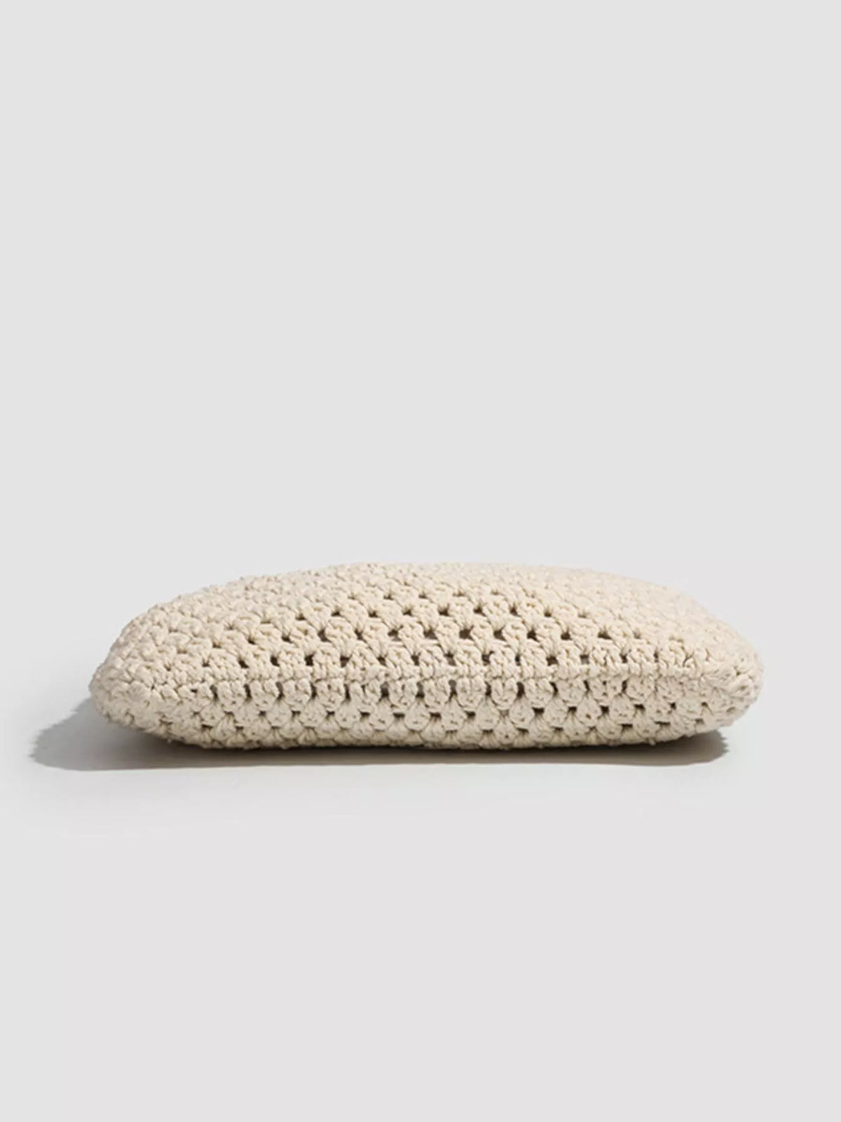Bottom profile of the ivory crochet tote showing the thick crocheted base.