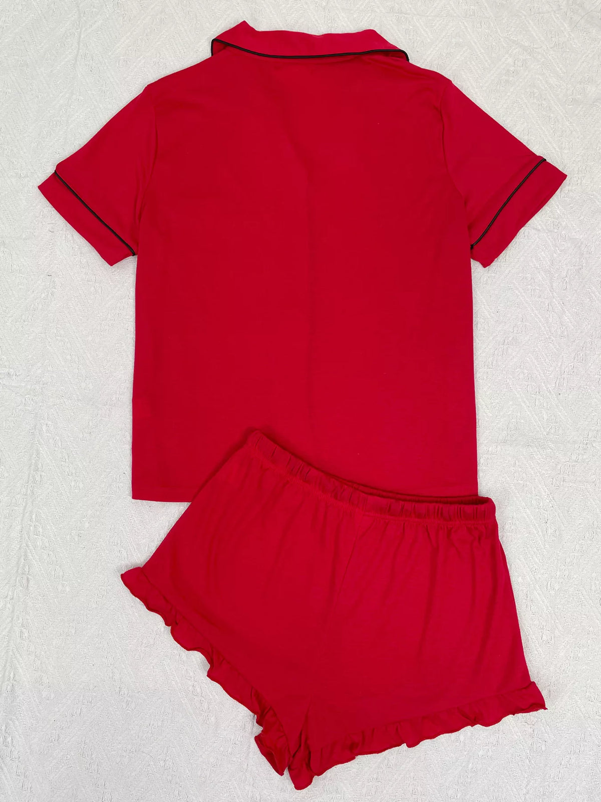 Back view of red button-down pajama top and matching ruffle shorts