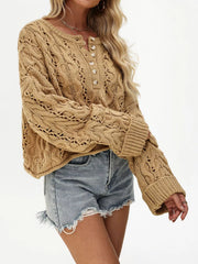 Women’s cable-knit half-button openwork sweater in tan front view with sleeve raised