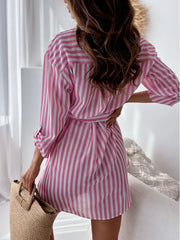 Three-quarter view of gray striped shirt dress with belt tie.