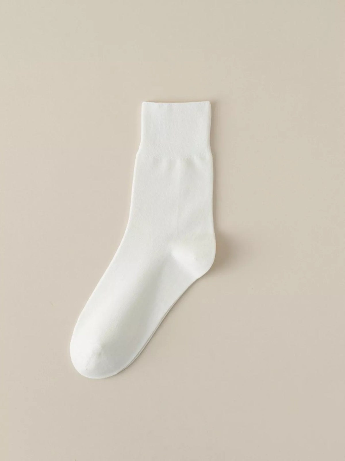 White solid-color crew sock displayed flat