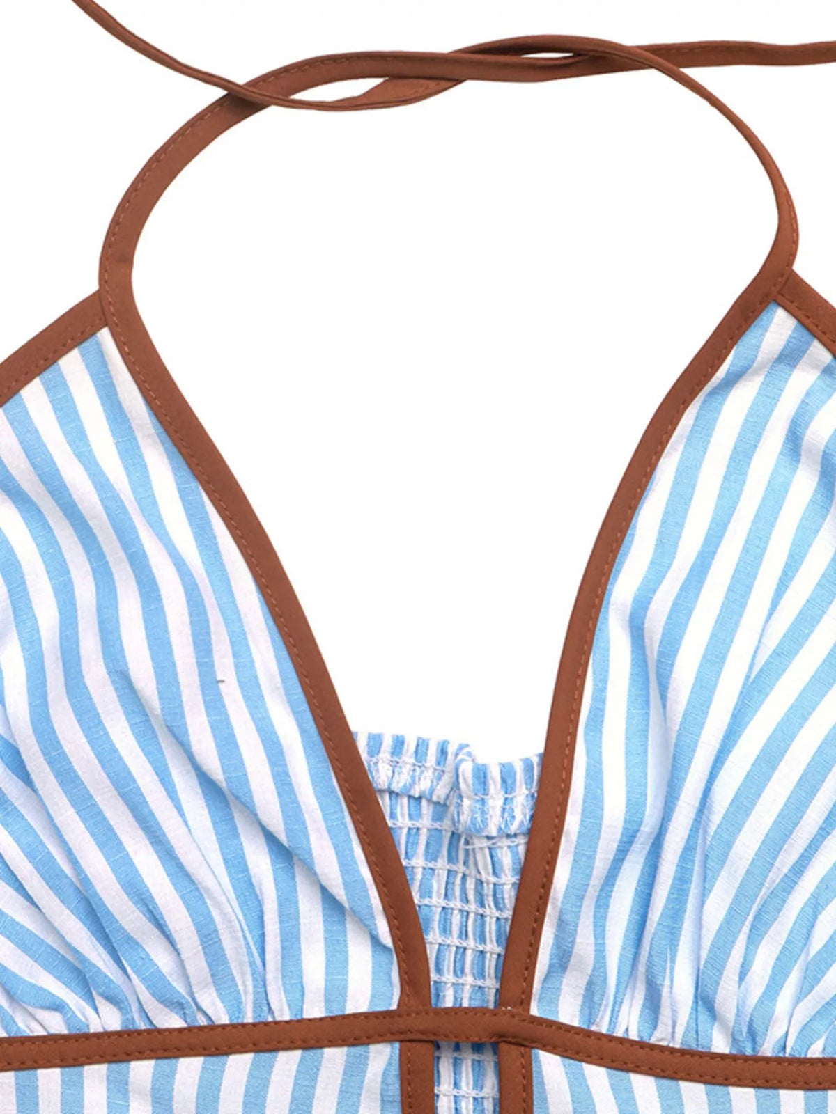 Close-up of halter straps and brown trim on striped dress