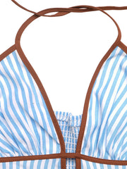 Close-up of halter straps and brown trim on striped dress