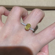 Copper-tone ring with an oval yellow center stone worn on a hand