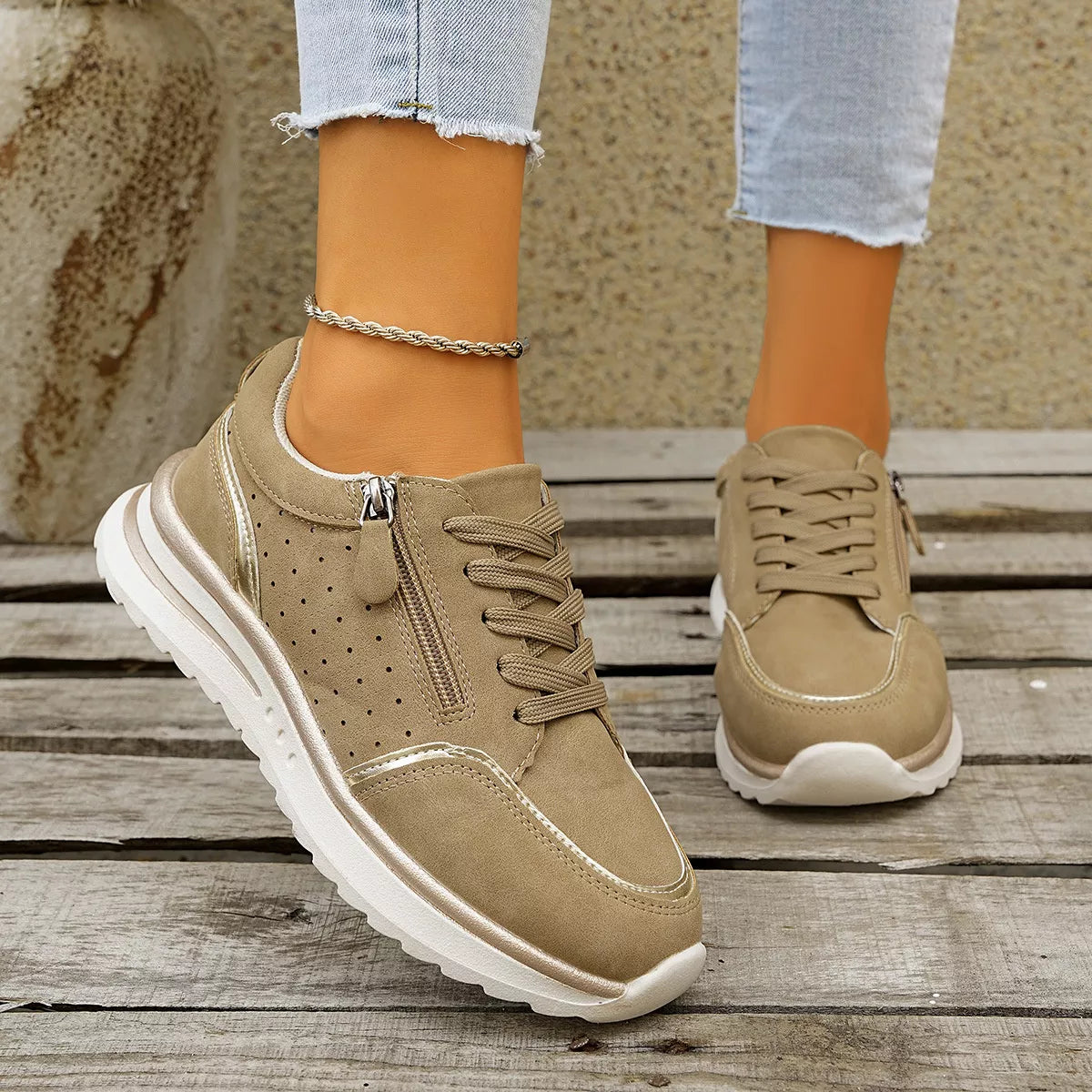 Taupe lace-up sneakers worn with jeans, front view