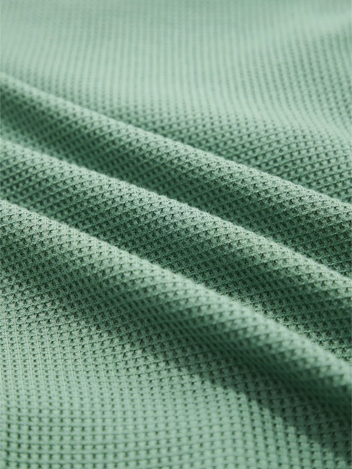 Close-up of sage waffle-knit fabric