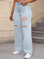 Three-quarter view of pale blue ripped jeans with a hand tucked in the front pocket